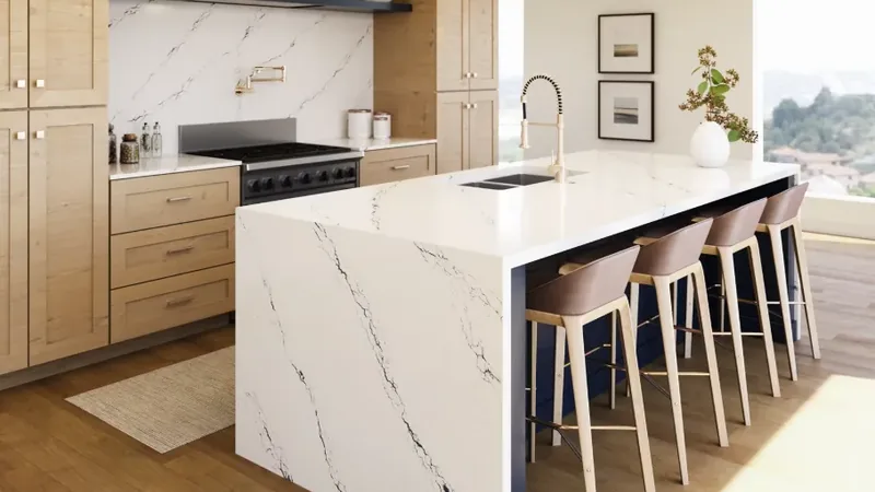 Installed white quartz waterfall island countertop with dramatic charcoal veining