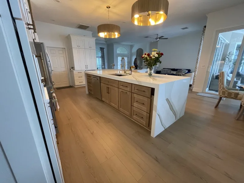 Open-plan kitchen with two islands and warm wood cabinet fronts